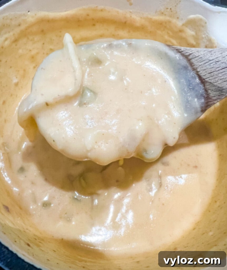 Savory Smothered Chicken Wings 8 smothered chicken gravy in a pot with a wooden spoon