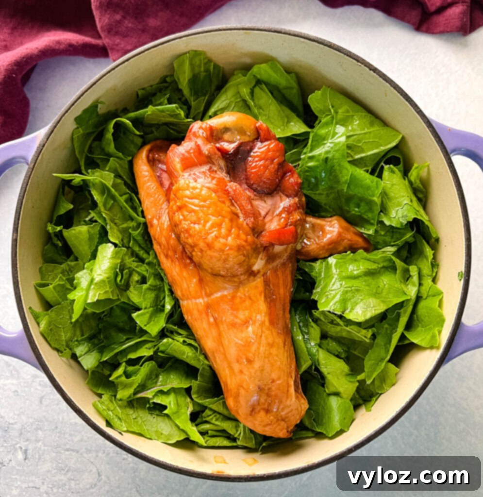 uncooked turnip greens and smoked turkey in a Dutch oven