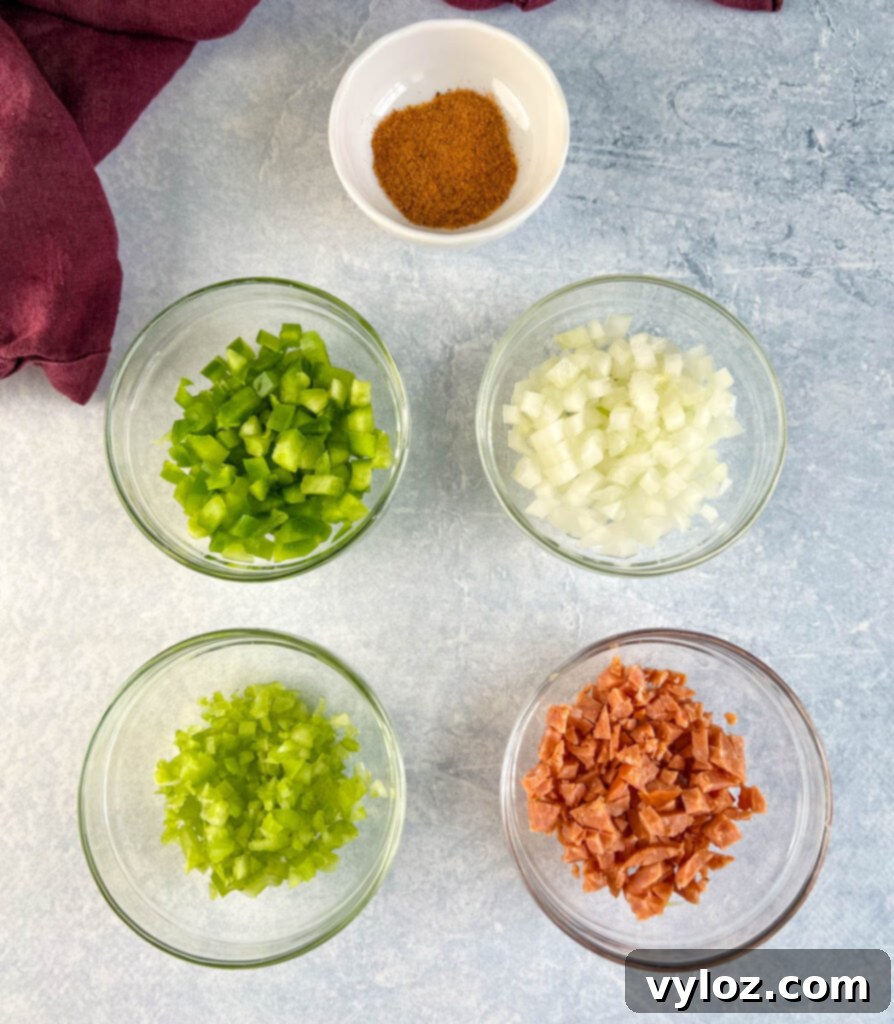 Perfectly Baked Stuffed Chicken 3 chopped vegetables, and chicken rub spices in separate glass bowls
