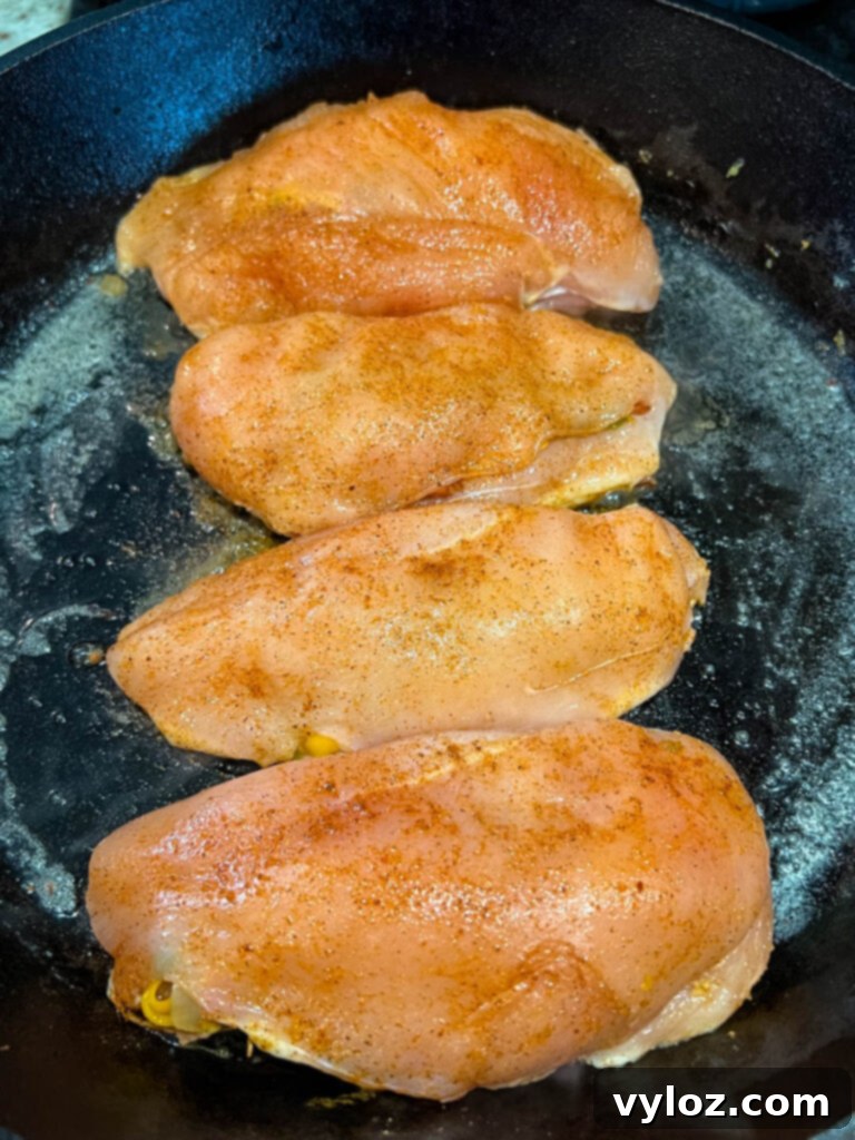 Perfectly Baked Stuffed Chicken 9 raw stuffed chicken breast in a cast iron skillet