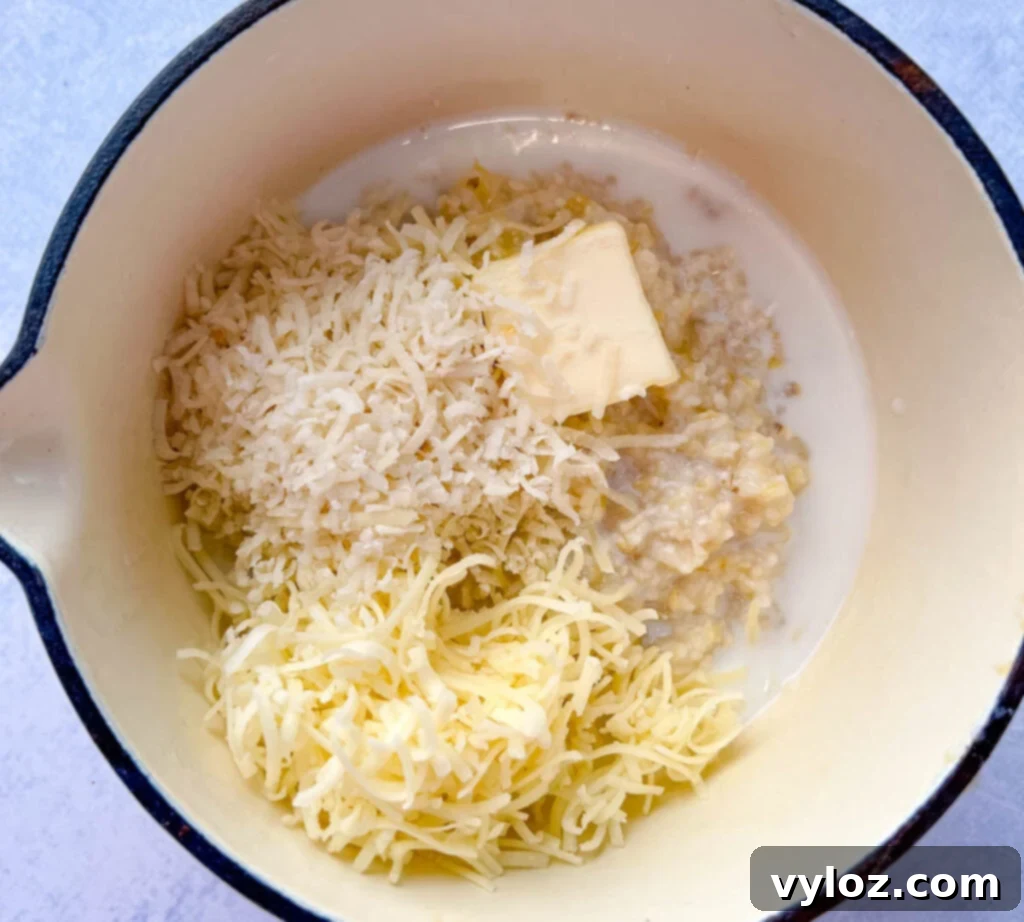 cooked grits in a pot with butter and cheese