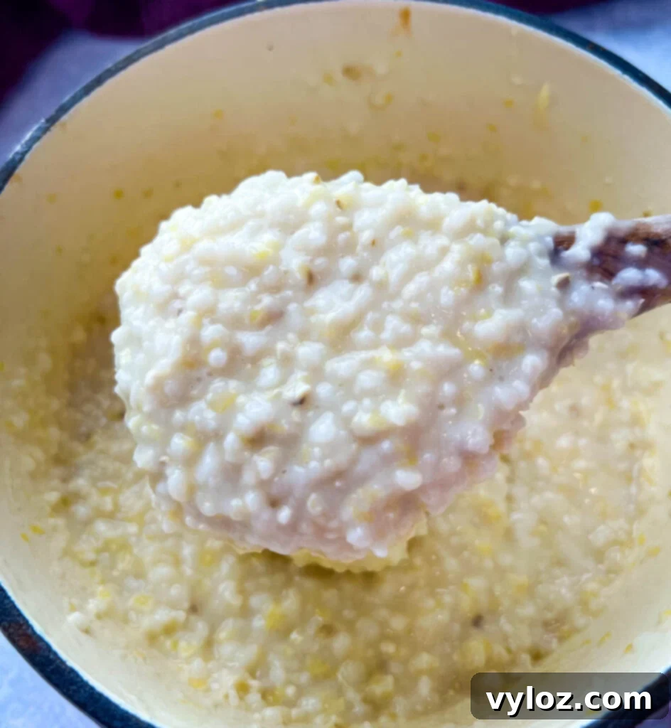 cooked grits in a pot with butter and cheese
