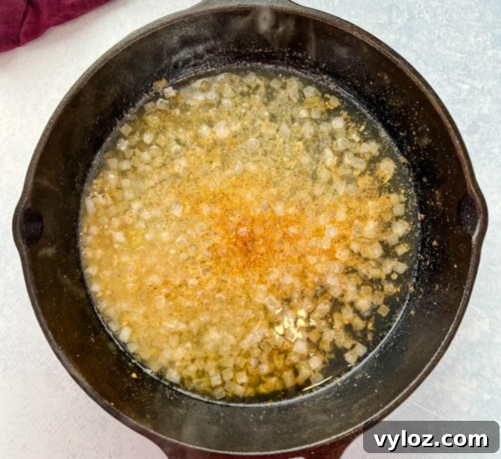 cooked onions and broth in a cast iron skillet