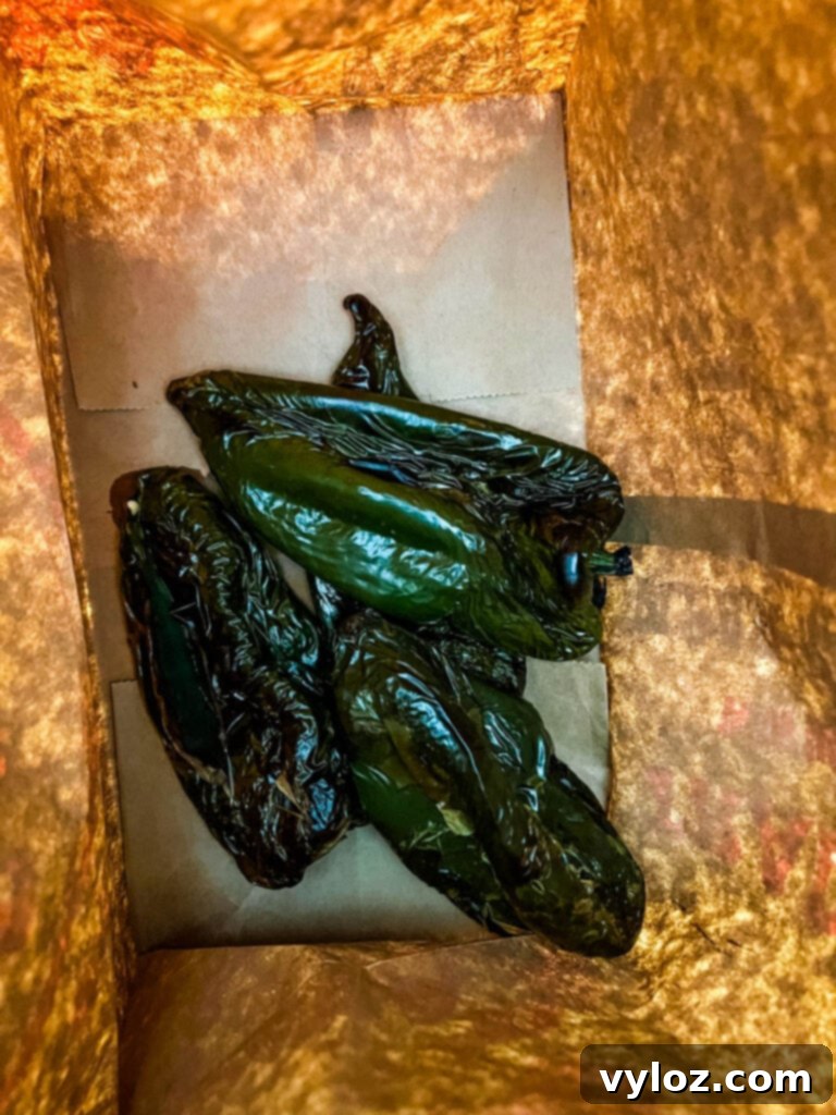 roasted poblano peppers in a paper bag