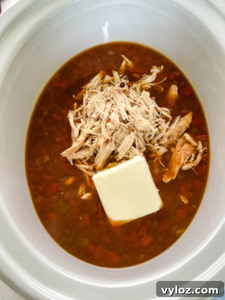 Hearty Slow Cooker Shredded Chicken Taco Soup 8 chicken taco soup in a slow cooker Crockpot with cream cheese