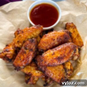 Fiery Honey Glazed Wings 12 honey hot wings on a plate with hot sauce