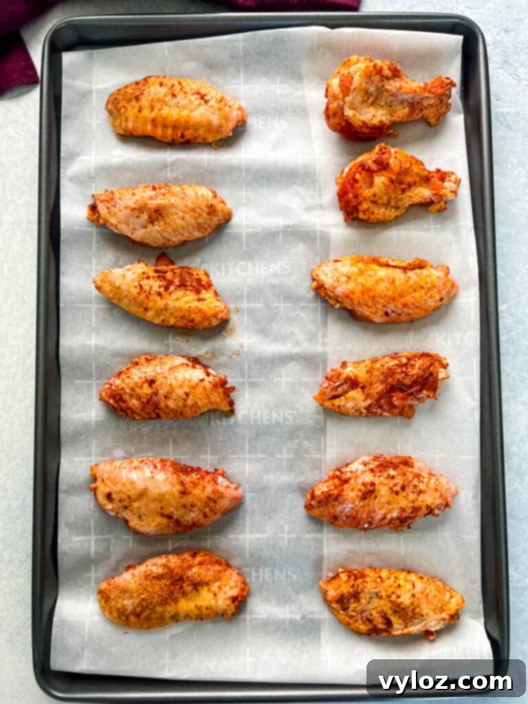 Fiery Honey Glazed Wings 7 seasoned chicken wings on a sheet pan