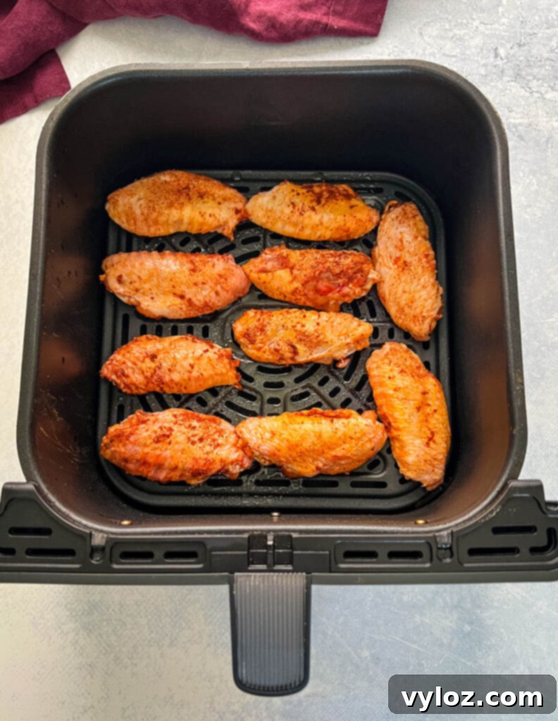 Fiery Honey Glazed Wings 8 raw seasoned chicken wings in an air fryer
