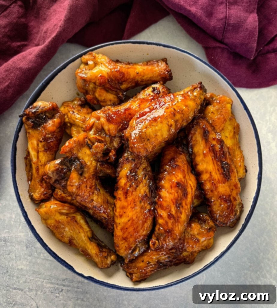 teriyaki chicken wings in a white and blue bowl