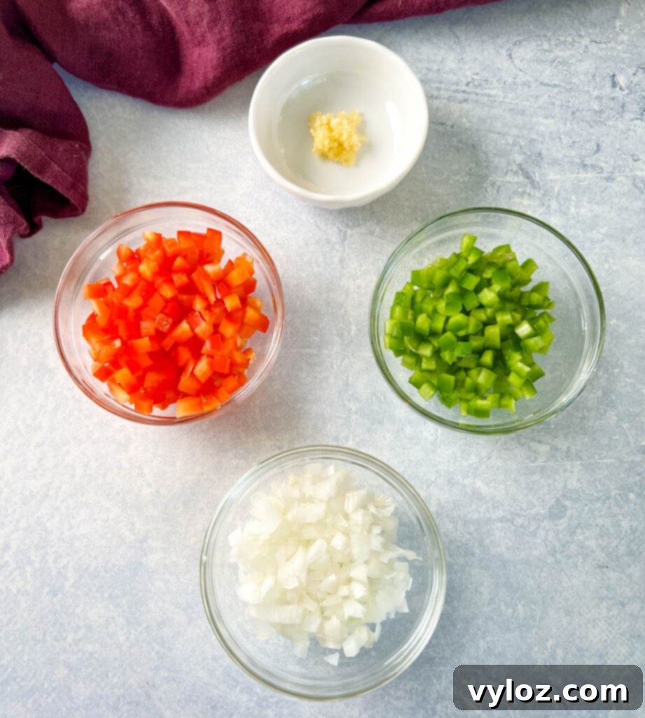 Hearty Butternut Squash Chili with Your Choice of Meat 4 Separate bowls of chopped red peppers, green peppers, onions, and minced garlic.