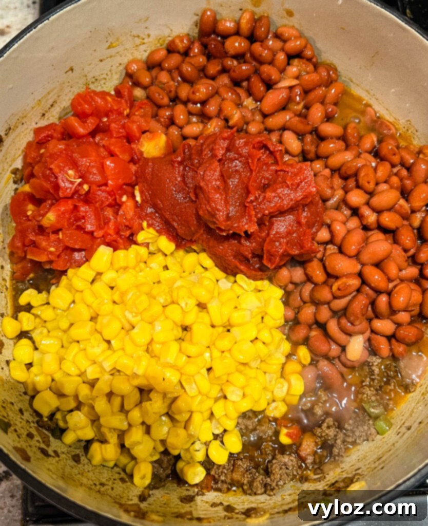Hearty Butternut Squash Chili with Your Choice of Meat 8 Butternut squash chili simmering in a large pot.