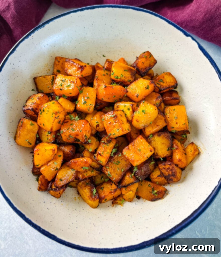Perfectly roasted air fryer butternut squash in a white serving bowl