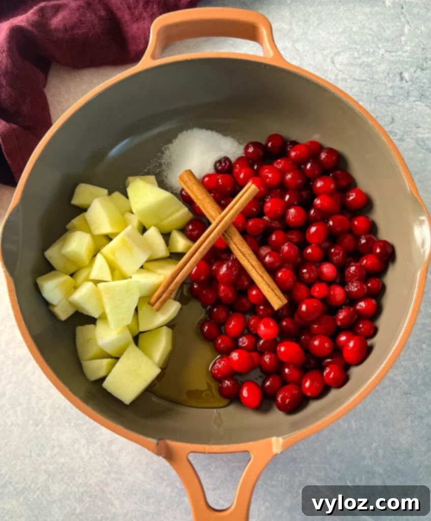 Apple Infused Cranberry Sauce 4 apples, cranberries, honey, cinnamon sticks, and sugar in a skilet