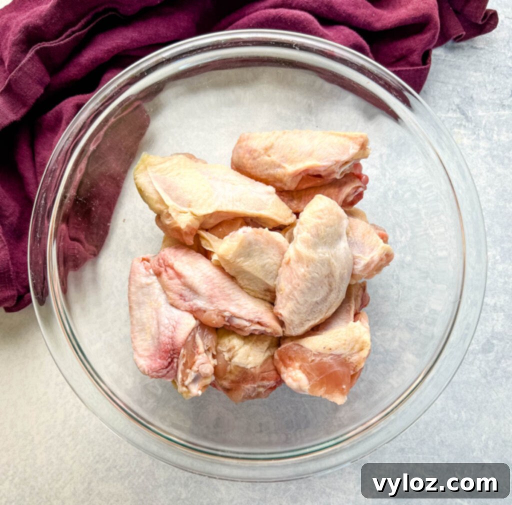 raw chicken wings in a glass bowl