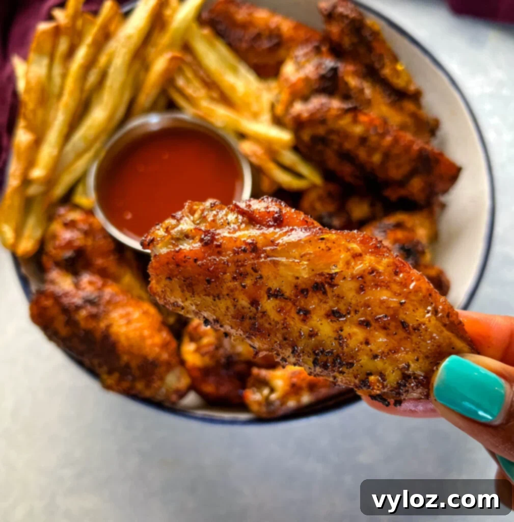 person holding Cajun chicken wing