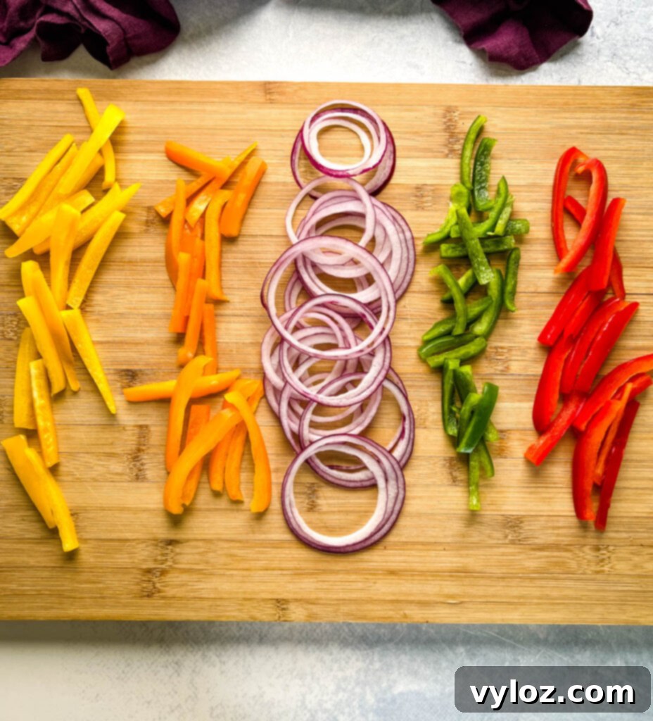 sliced bell peppers and onions on a cutting board