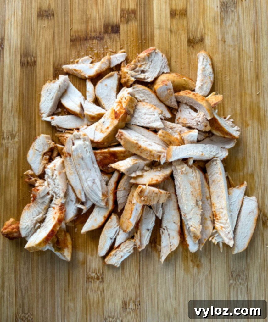 sliced chicken breasts on a bamboo cutting board