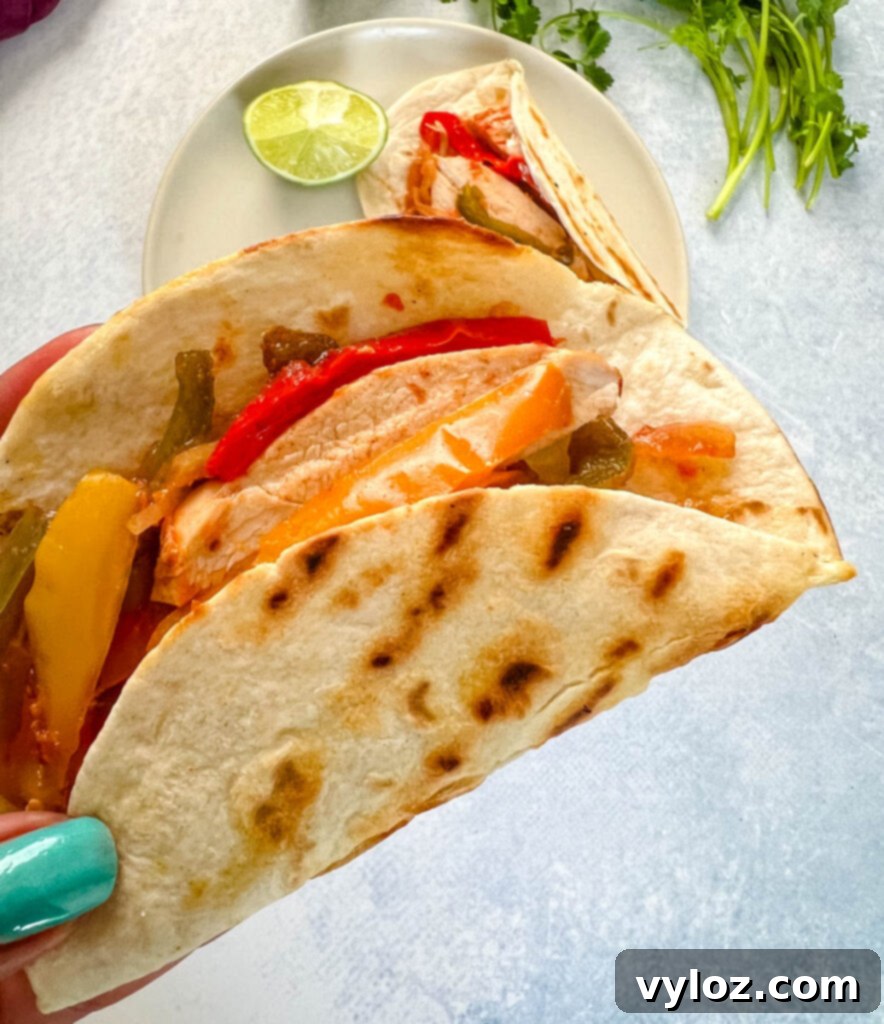 person holding slow cooker Crockpot chicken fajita