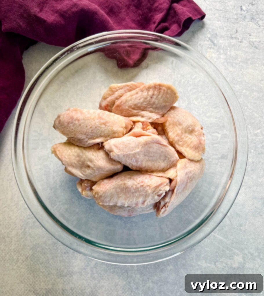 raw split chicken wings in a glass bowl