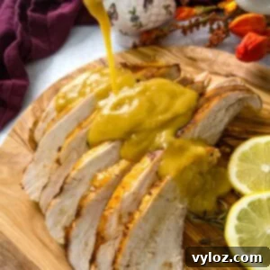 gravy drizzled over slices of Crockpot slow cooker turkey breast on a cutting board