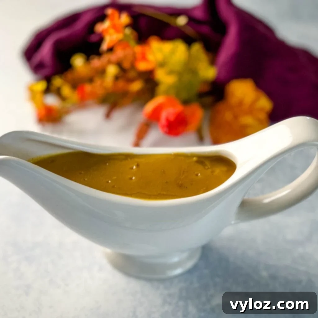 A bowl of rich, homemade turkey gravy made from drippings, ready to serve
