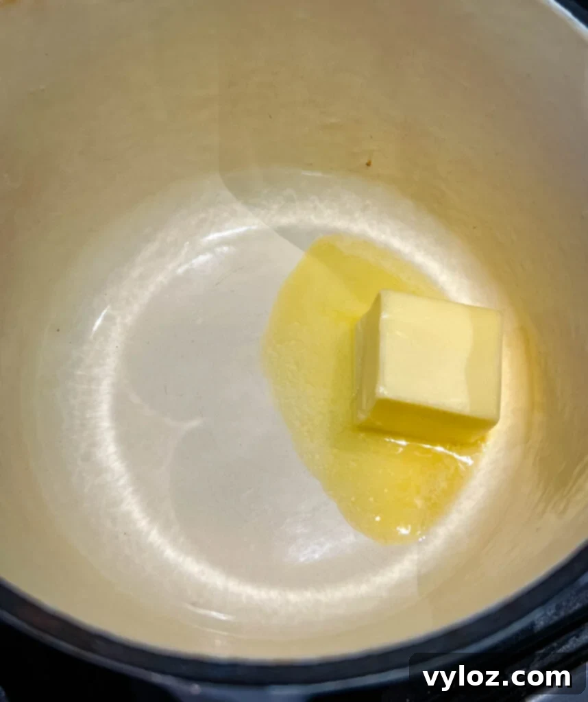 Melted butter simmering in a saucepan on a stovetop, ready for roux