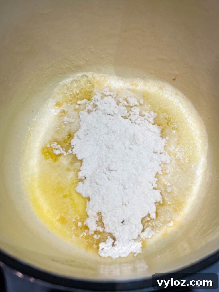 Melted butter combined with all-purpose flour in a saucepan, forming a roux