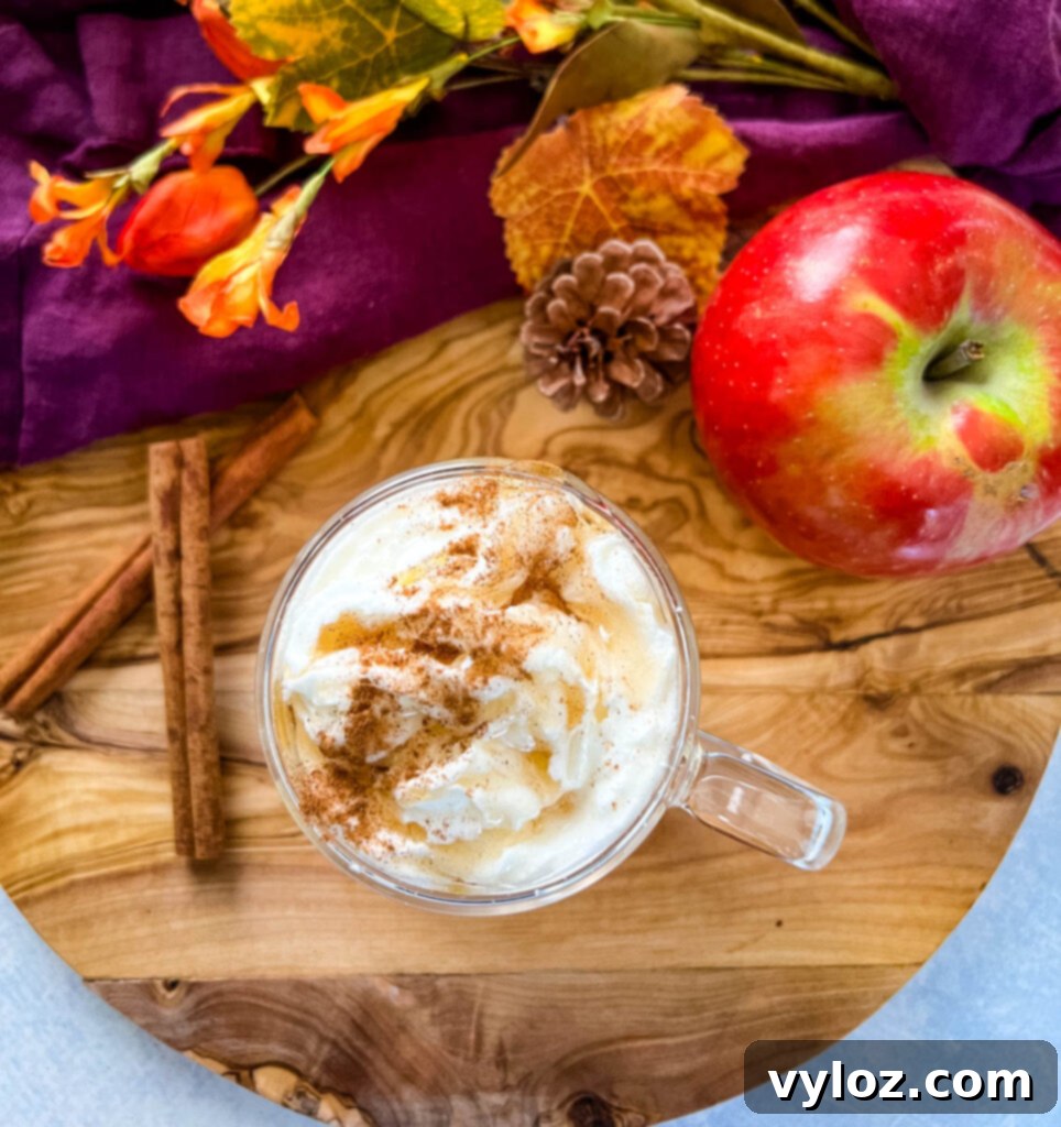 Caramel Apple Bliss 8 Cozy glass mug of homemade caramel apple spice cider, topped with whipped cream and caramel drizzle