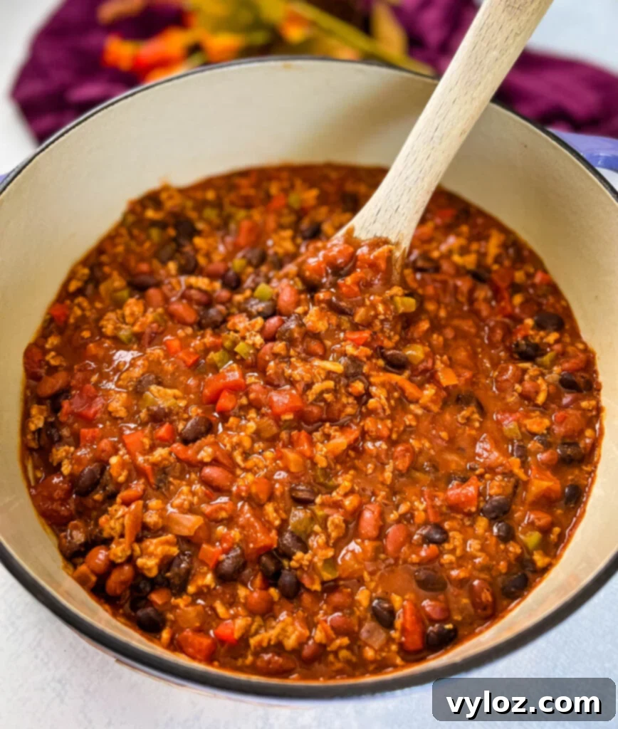 Hearty Ground Chicken Chili 11 Close-up of hearty ground chicken chili with beans, simmering richly in a Dutch oven.