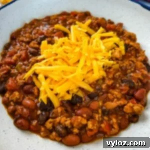 Hearty Ground Chicken Chili 9 ground chicken chili with cheese in a white bowl