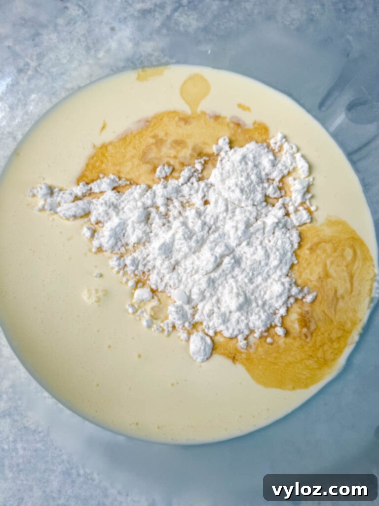 Zero Sugar Whipped Cream 5 Heavy whipping cream, powdered sweetener, and vanilla extract mixing in a glass bowl