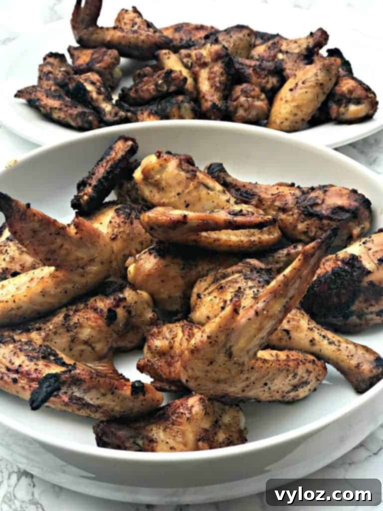 Grilled BBQ chicken wings in a large white bowl, ready to serve
