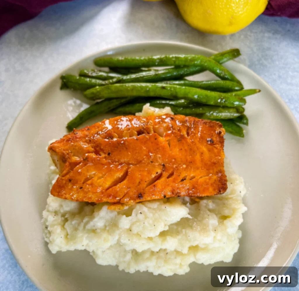 lemon pepper fish, mashed potatoes, and green beans on a plate