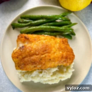 lemon pepper fish, mashed potatoes, and green beans on a plate