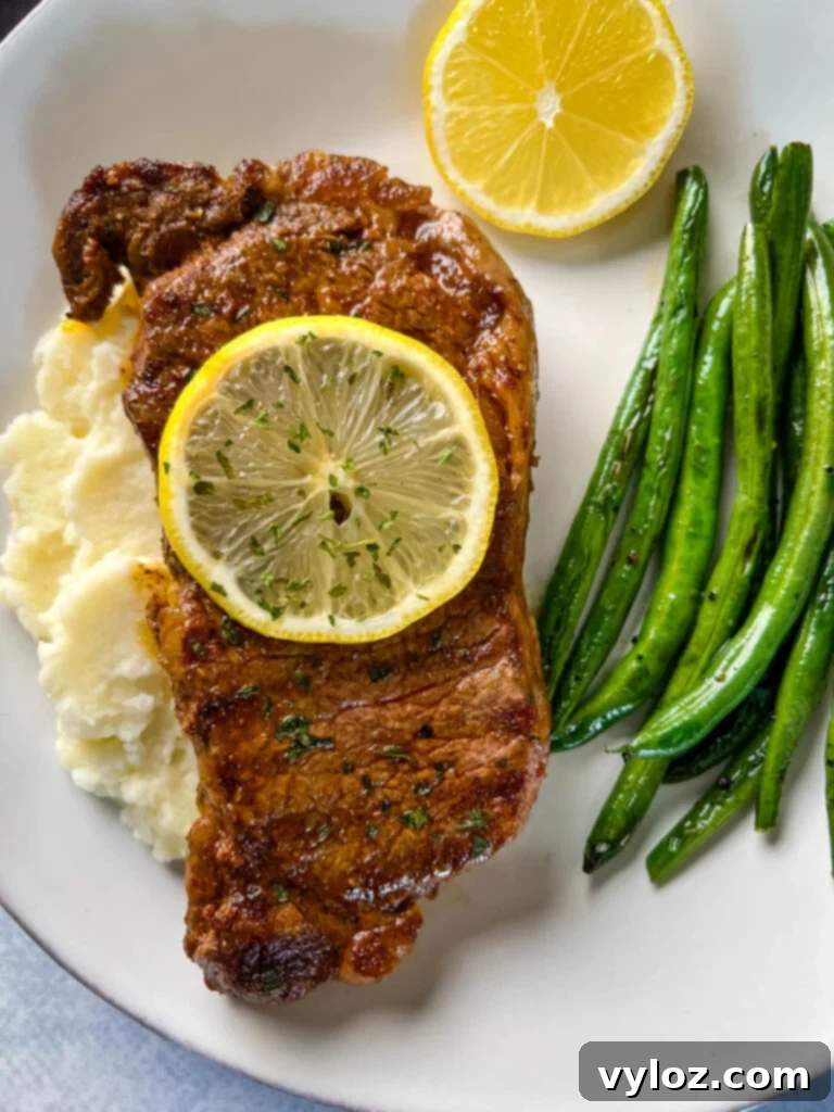 Zesty Lemon Pepper Steak 2 lemon pepper steak with lemon, mashed potatoes, and green beans