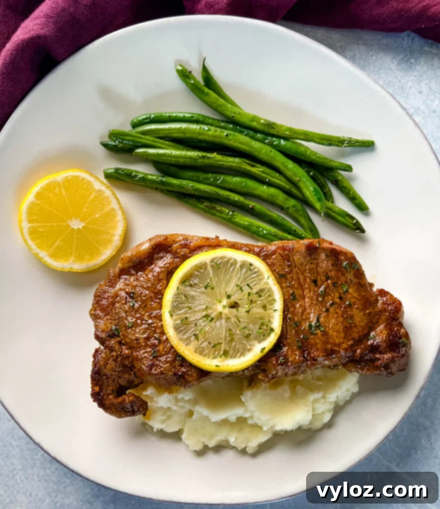 Zesty Lemon Pepper Steak 12 lemon pepper steak with lemon, mashed potatoes, and green beans