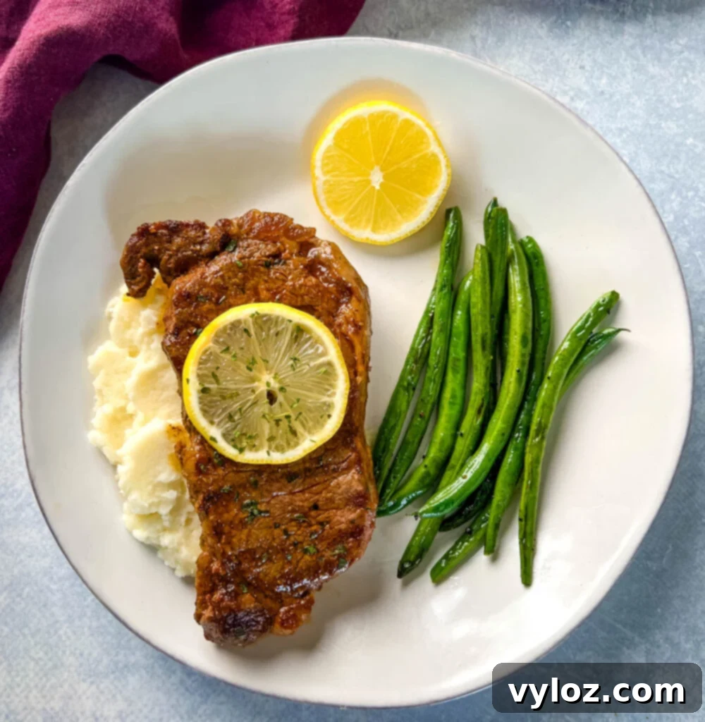Zesty Lemon Pepper Steak 13 lemon pepper steak with lemon, mashed potatoes, and green beans
