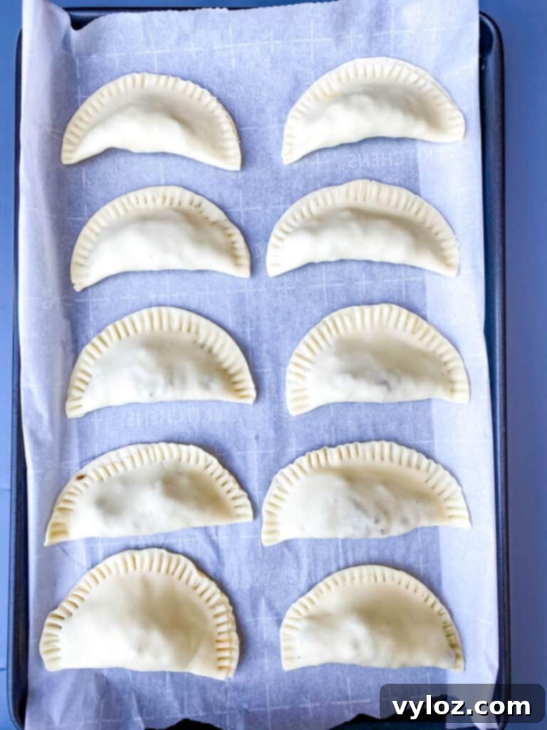 A collection of beef and cheese empanadas arranged on a platter, ready for guests.