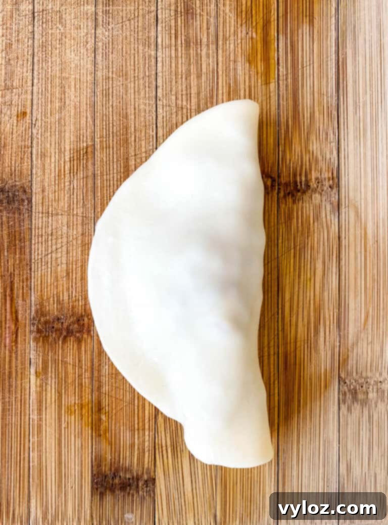A close-up shot of several beef and cheese empanadas, highlighting their crispy texture and delicious filling.