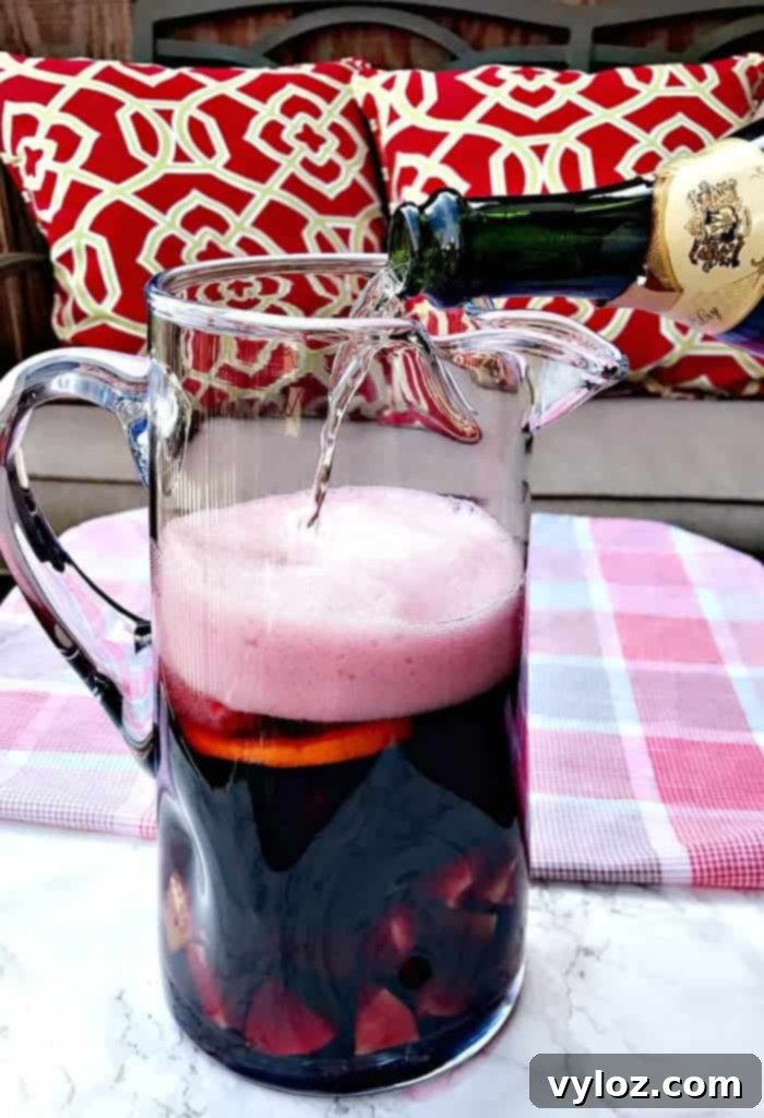 Pitcher of Red Wine Sangria Champagne Mimosas with fruit slices