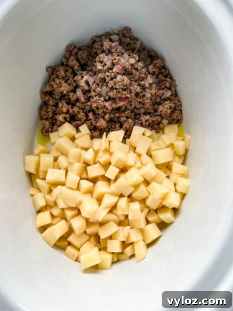 Hearty Slow Cooker Cheeseburger & Potato Soup 7 cooked ground beef and diced potatoes in a Crockpot slow cooker
