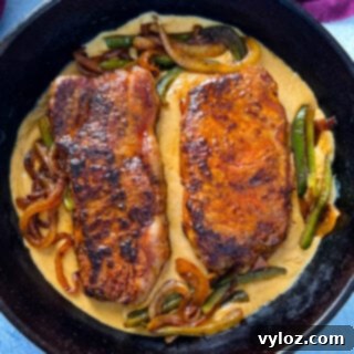 smothered steak with gravy in a cast iron skillet