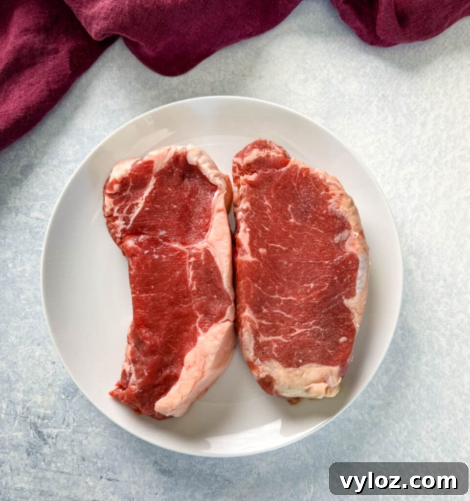 raw sirloin steaks on a plate