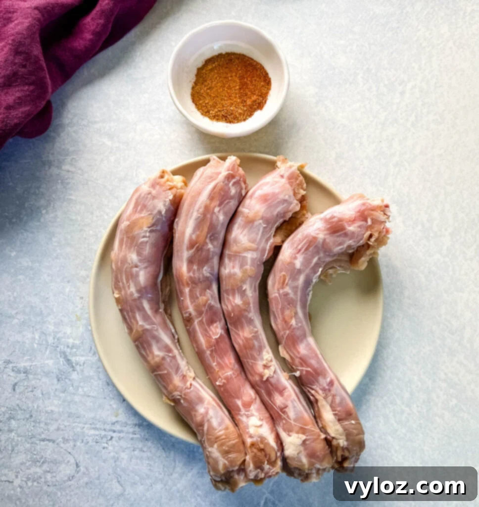 Raw turkey necks seasoned with spices on a plate