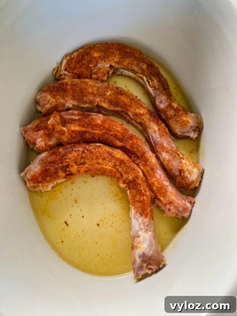 Raw, seasoned turkey necks in a Crockpot slow cooker