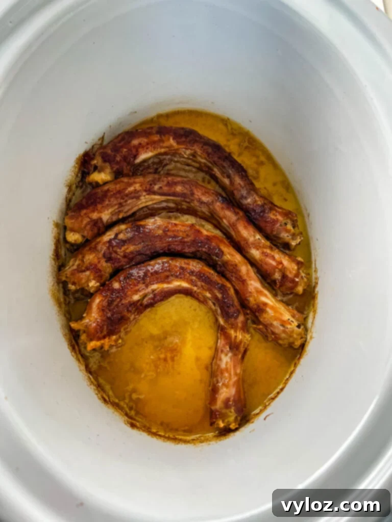 Cooked turkey necks in a Crockpot slow cooker, ready to serve