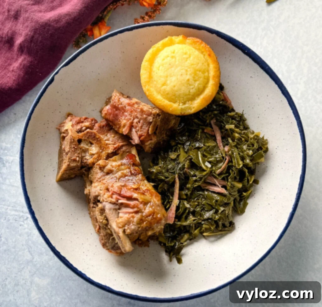 Tender slow cooker Crockpot neck bones served in a bowl with collard greens and cornbread, highlighting a classic Southern comfort meal