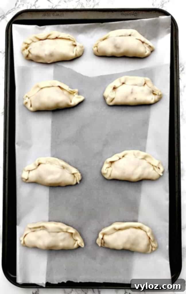 Savory Shrimp Red Pepper Cream Cheese Empanadas 4 Close-up of golden brown Shrimp Red Pepper Cream Cheese Empanadas revealing the delicious filling