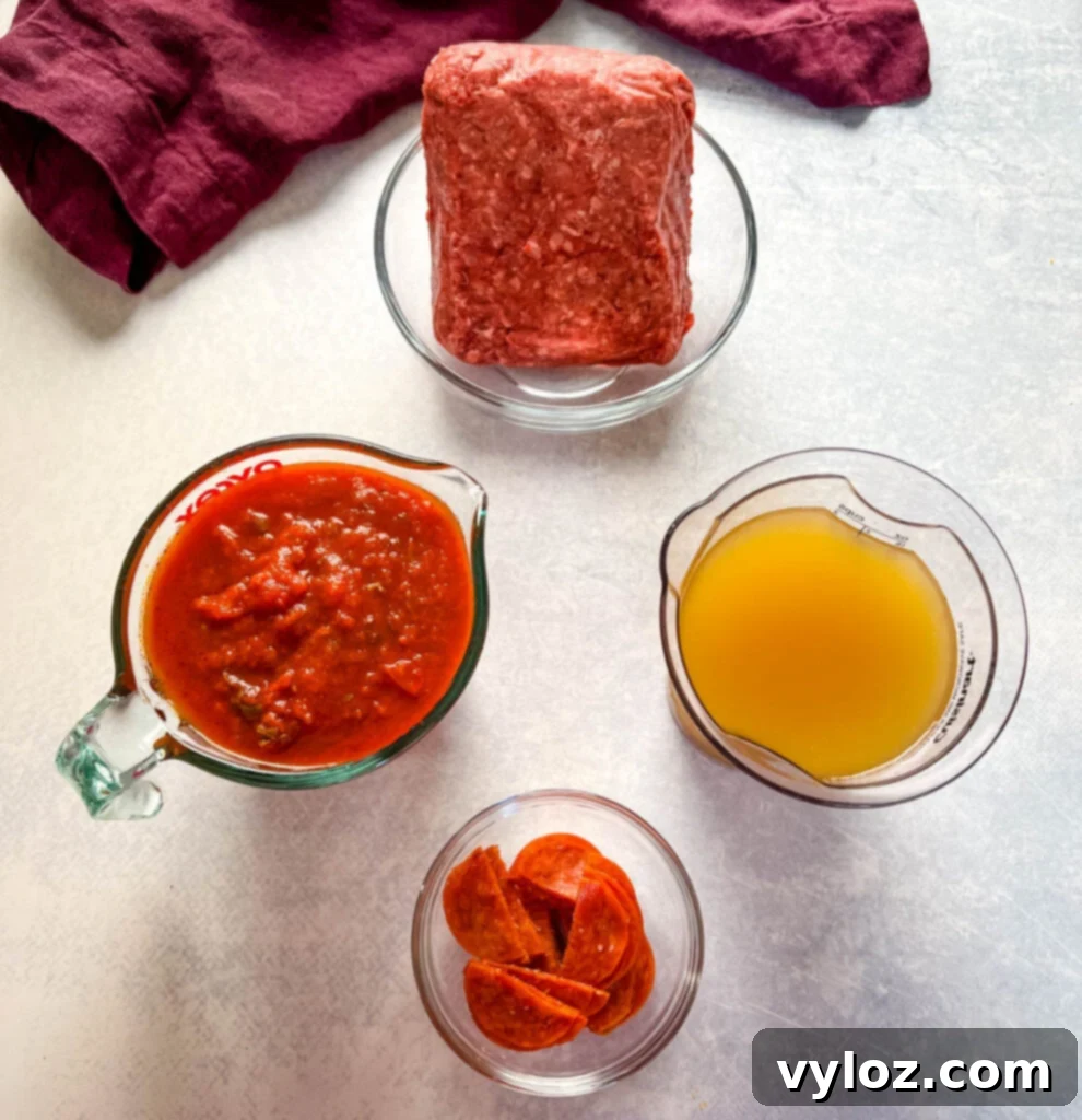 Prepped ingredients for pizza soup: separate glass bowls holding rich ground beef, bright marinara sauce, savory beef broth, and sliced pepperoni