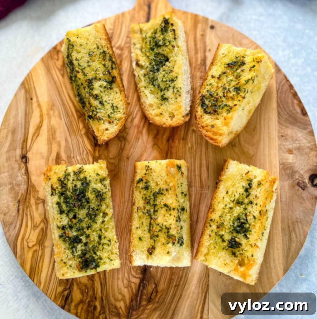 air fryer garlic bread on a wooden cutting board